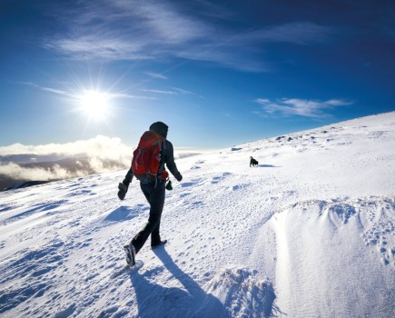 Woman hiking through snow