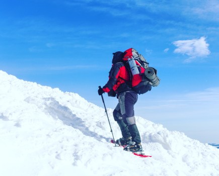 A winter mountaineer staying warm in winter