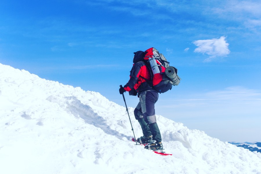 A winter mountaineer staying warm in winter