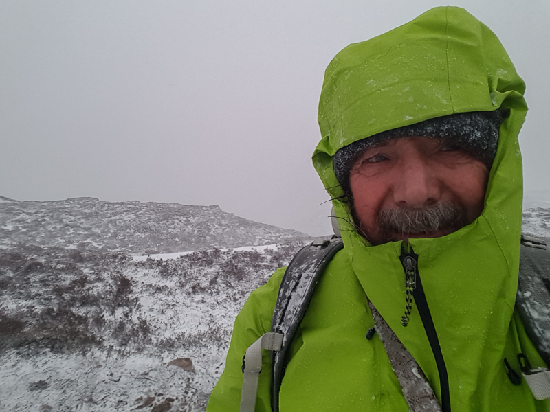 Chris Townsend (author) in green Patagonia Ascenionist Jacket with hood up