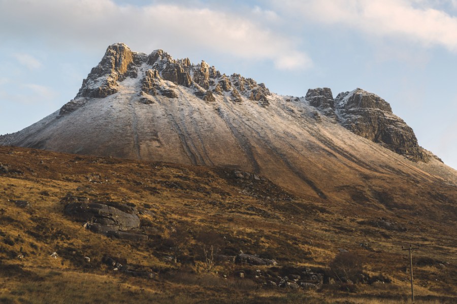 Snow dusted brown rocky peak of Stac Pollaidh