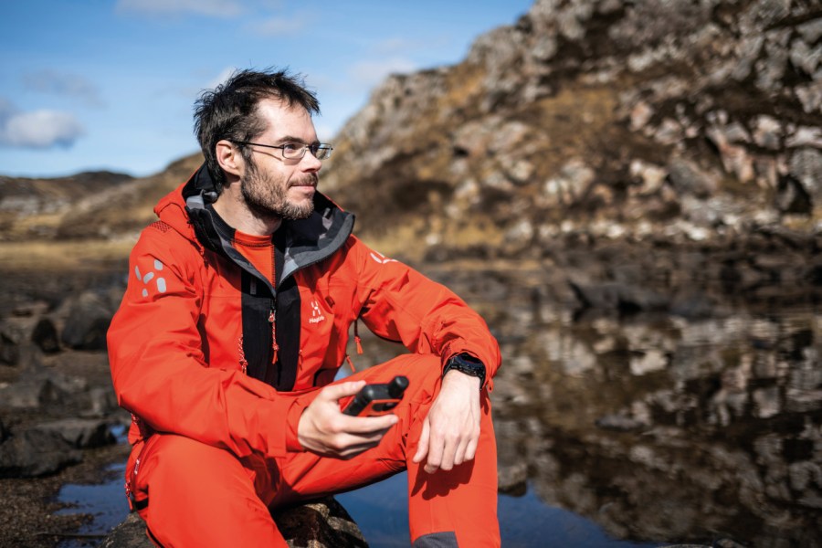 Man wearing red Haglofs L.I.M series Z/T Mountain GTX Pro Waterproof Shell pant and jacket