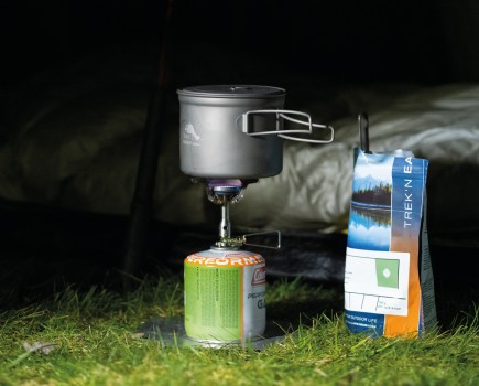 Packet of Trek'N'Eat hiking food nex to gas stove