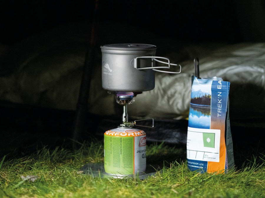 Packet of Trek'N'Eat hiking food nex to gas stove