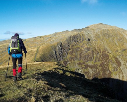 Man standing on top of a mountain in snowdonia