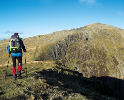 Man standing on top of a mountain in snowdonia