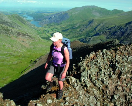 Woman hiking on narrow ridge