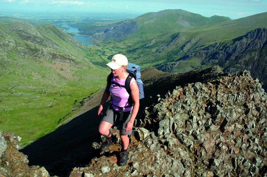 Woman hiking on narrow ridge