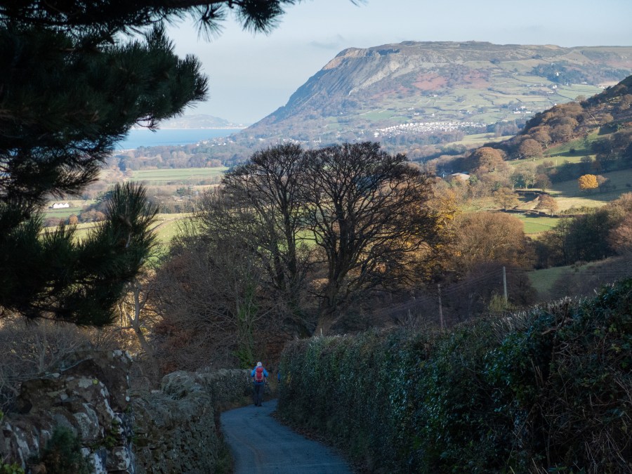 Minor road approaching the hamlet of Crymlyn with Penmaenmawr in the background