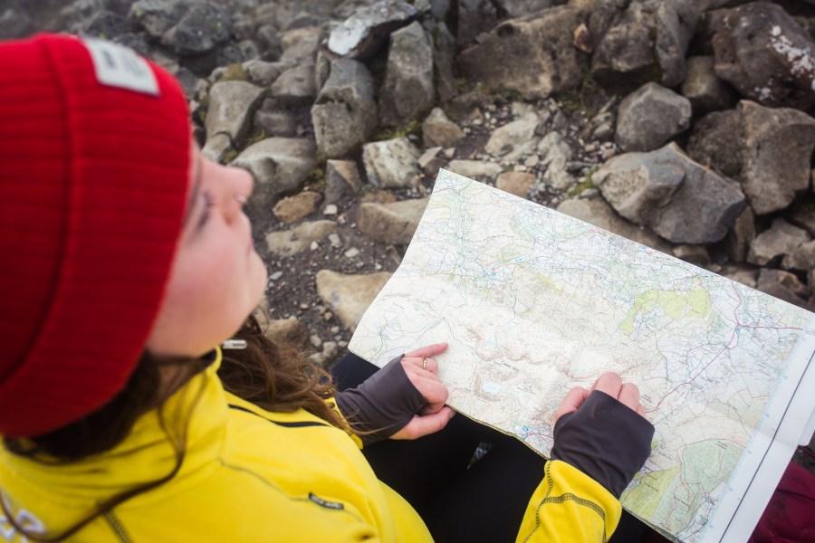 A walker checking a map at the summit of Cadair Idris.