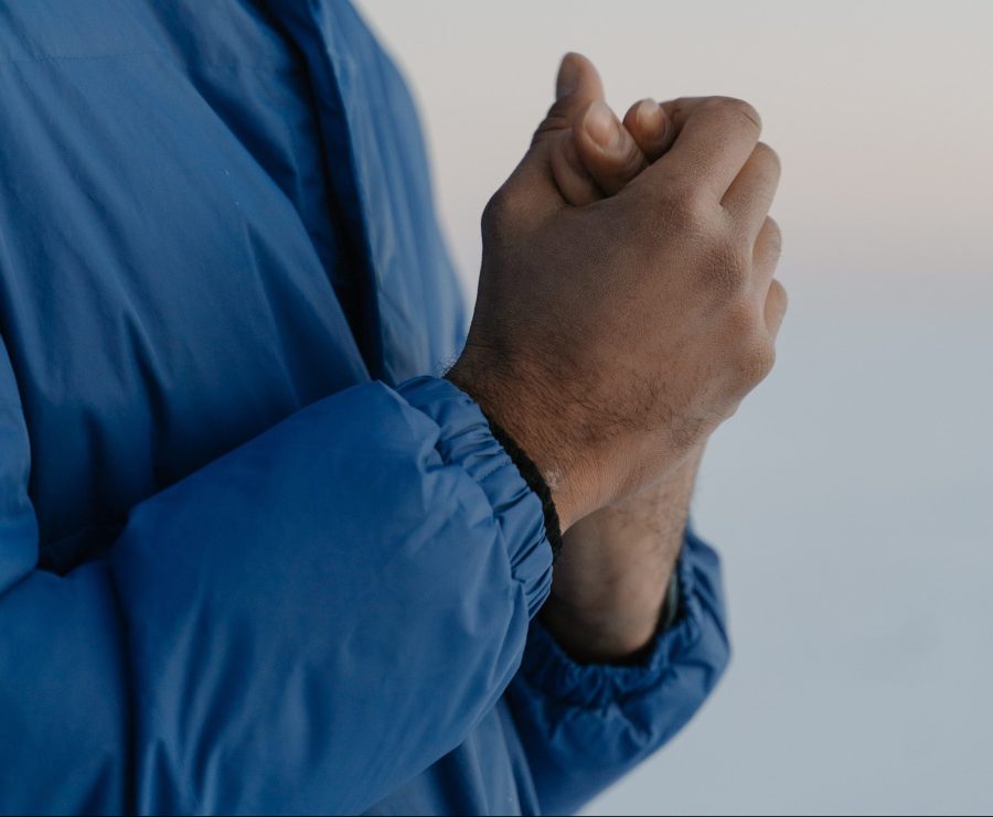 A man without hand warmers for hiking or gloves in the cold