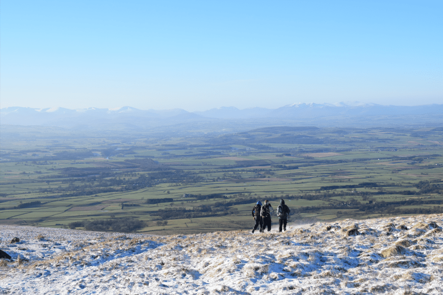 Three hikers descending Cross Fell