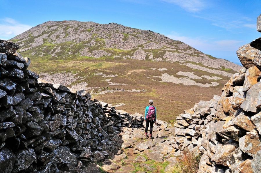 Yr Eifl 6: Leaving Tre’r Ceiri via an ancient entrance in the high defensive wall, with Garn Goch beyond.JPG