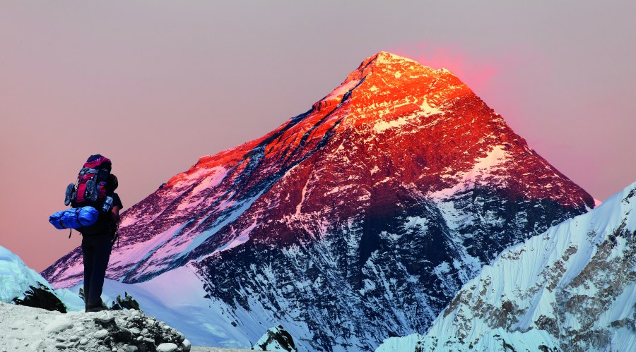 Evening colored view of Mount Everest from Gokyo valley with tourist on the way to Everest base camp, Sagarmatha national park, Khumbu valley, Nepal