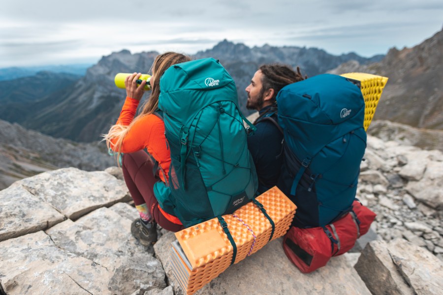 Two hikers with one of the multi-day different types of backpack from Lowe Alpine.