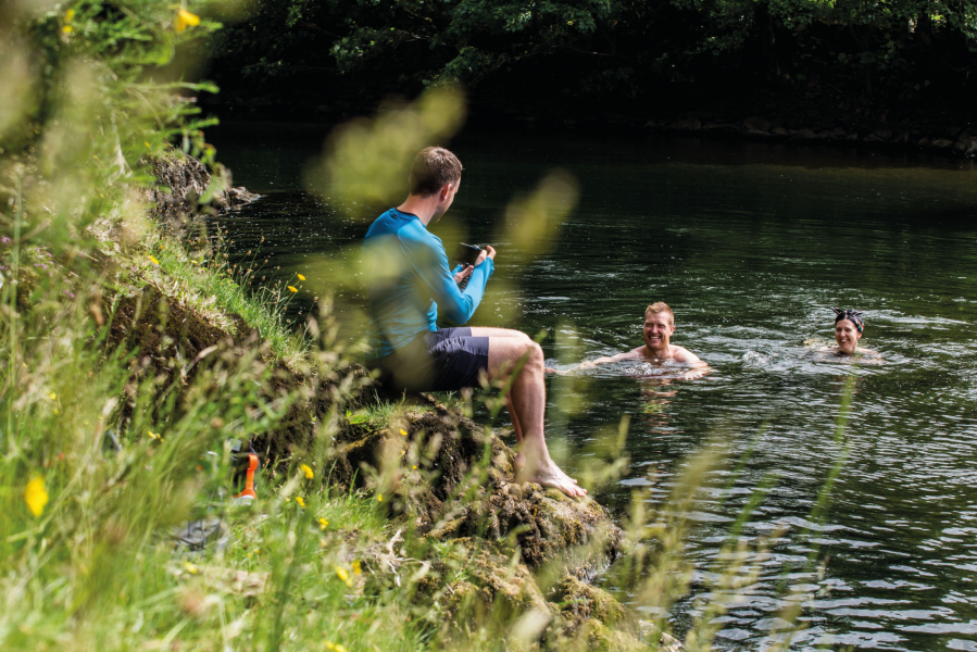 how to hike in heat - hikers on a lake district swim