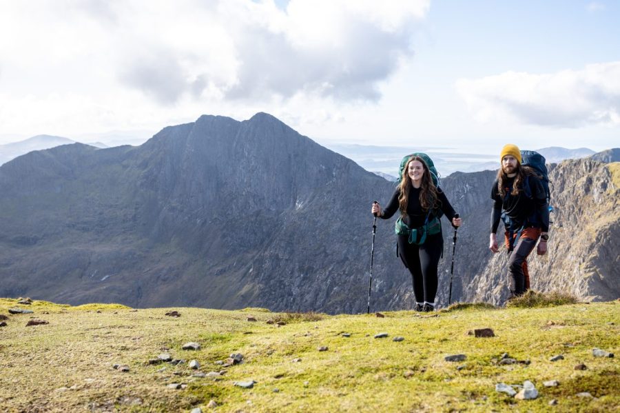 A hiker on a quiet hikes up Snowdon on the Snowdon Girdle using hiking poles Credit: Ben Cannon