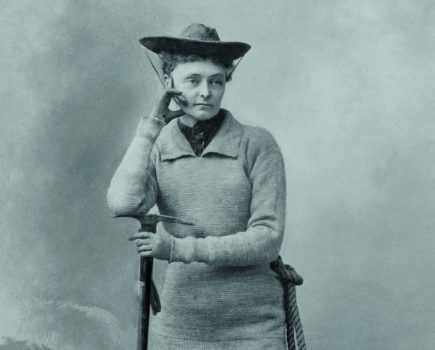 suffragette mountaineer Miss Annie S. Peck, in her mountaineering gear, 1911. She wears a tunic sweater over trousers tucked into gaiters over climbing boots. In 1895, her masculine climbing costume was scandalous. In 1908, at the age of 58, she climbed Peru's Mount, reaching the height of 21,812, higher than and man or women had climbed to that date. Her claim was contested by Fanny & William Hunter Workman (BSLOC_2018_4_204)