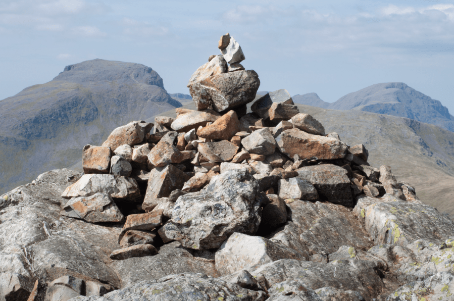 Cairn on summit of Glaramara with Great Gable