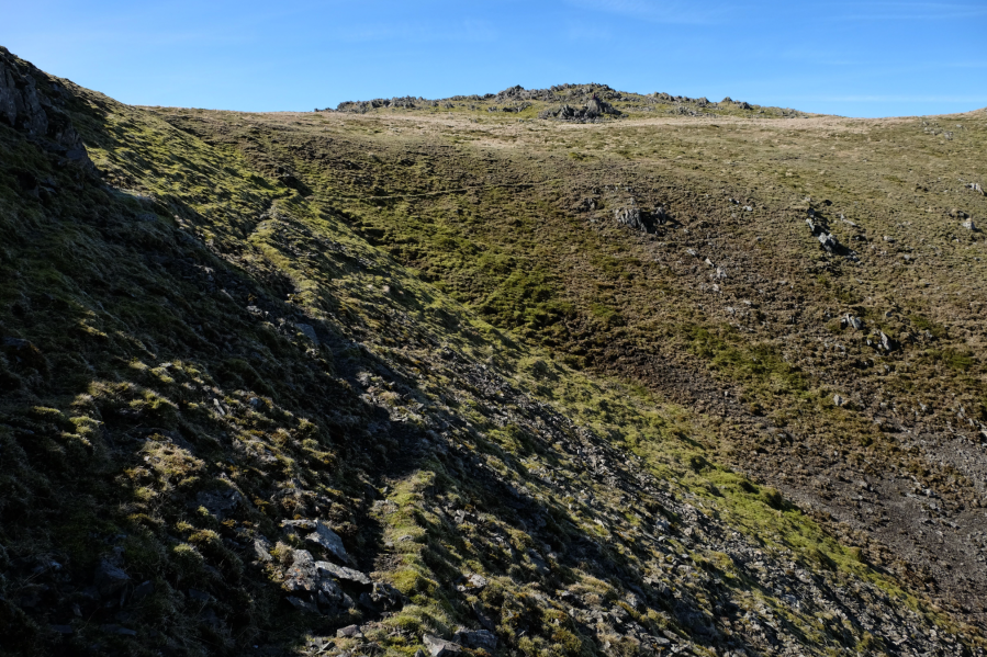 wp5_A faint trail swings west-north-west around the head of a scree-filled gully.JPG