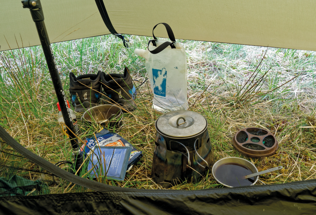 Kitchen in the Hilleberg Anaris porch in the rain. Trail Designs Classic Tri-Ti stove system_