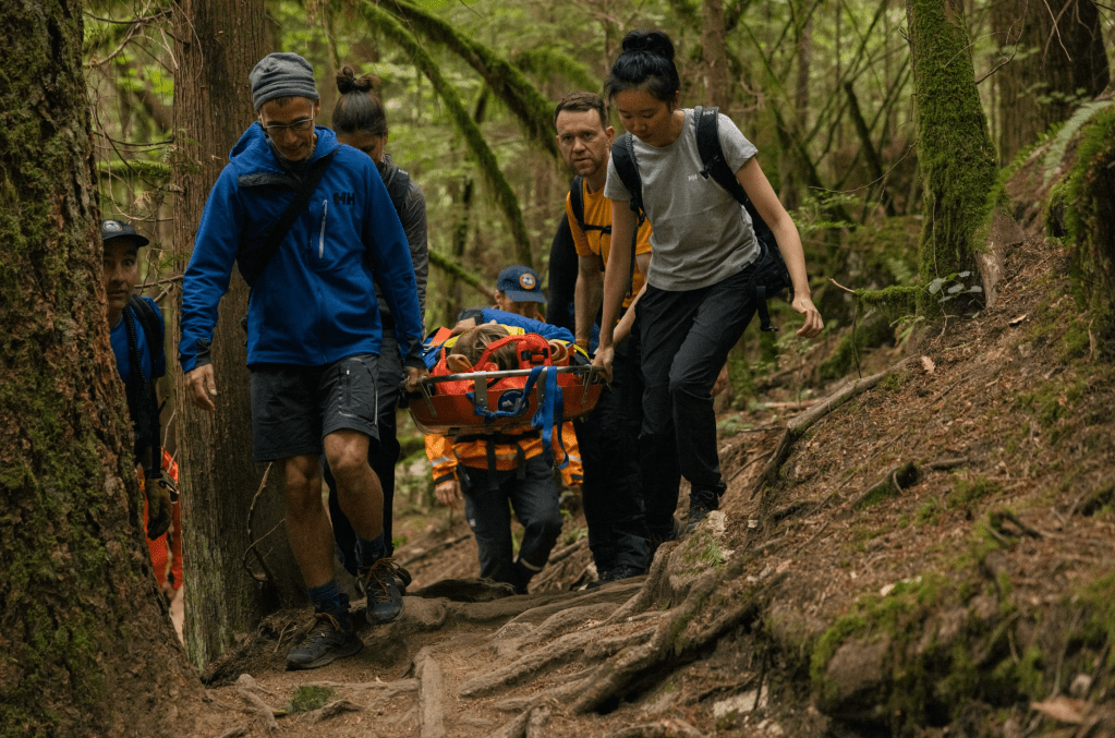 Taking part in a mock rescue operation with Squamish Search and Rescue team. Credit: Michael Overbeck