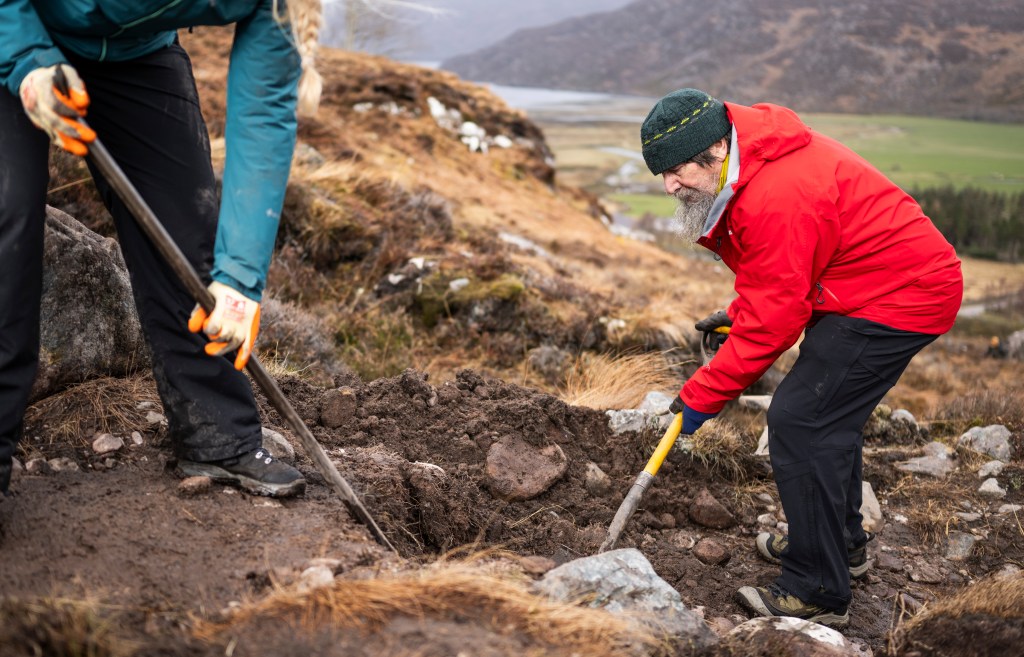 Chris Townsend helping to dig out a new section of path in Keela kit