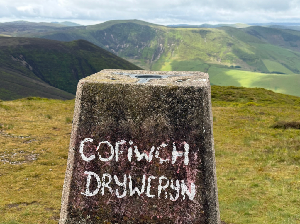 The words on the Foel Fadian trig translate as “Remember Tryweryn” - a common marking in Wales honouring the flooded village of Capel Celyn, lost to a reservoir supplying water to Liverpool. Credit: Francesca Donovan