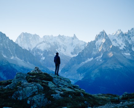 Man looking at the mountains near Chamonix, France. Old film style.