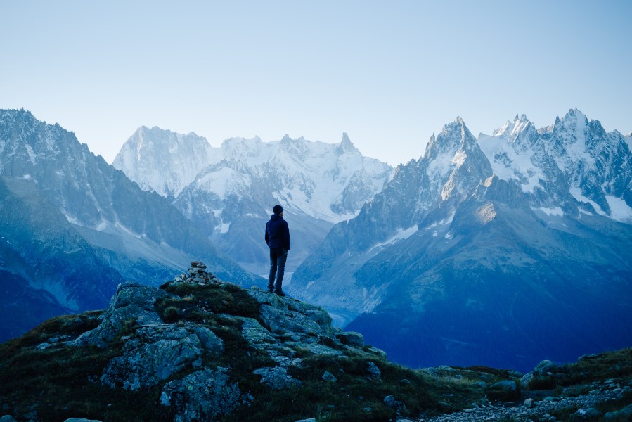 Man looking at the mountains near Chamonix, France. Old film style.