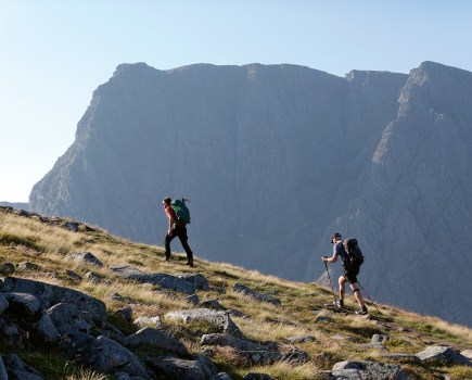 Two walkers ascending Carn Mor Dearg with Ben Nevis in the distance_credit Nicola Hardy