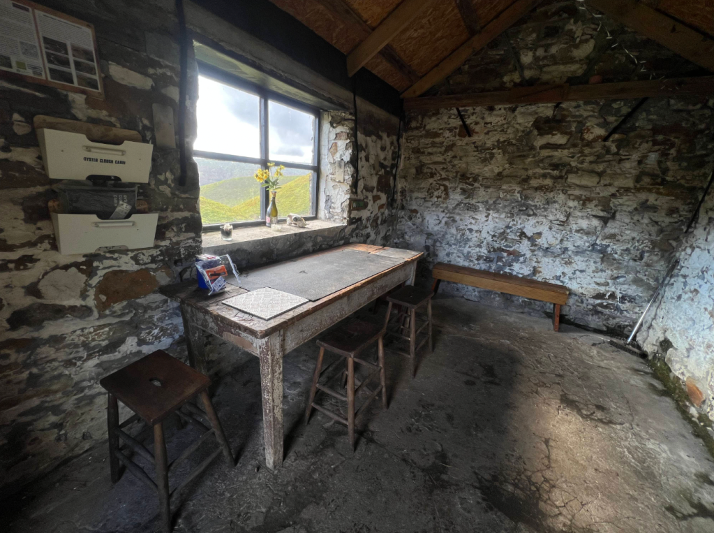 The cabin nestled in its clough