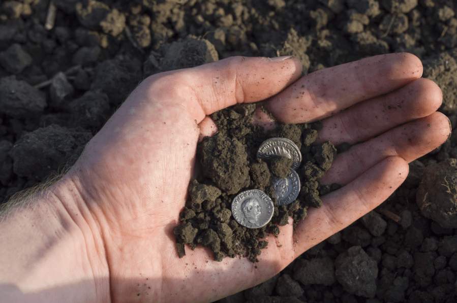 strolls through history - Roman silver coin featuring a portrait of Caesar. Credit: nevio / Shutterstock