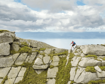 grahams round *DPS*After a kicking down the west coast, Lorraine dances across the top of the final west coast hill enjoying the longed for sunshine. Mullach Buidhe, Arran. Credit Kev Woods