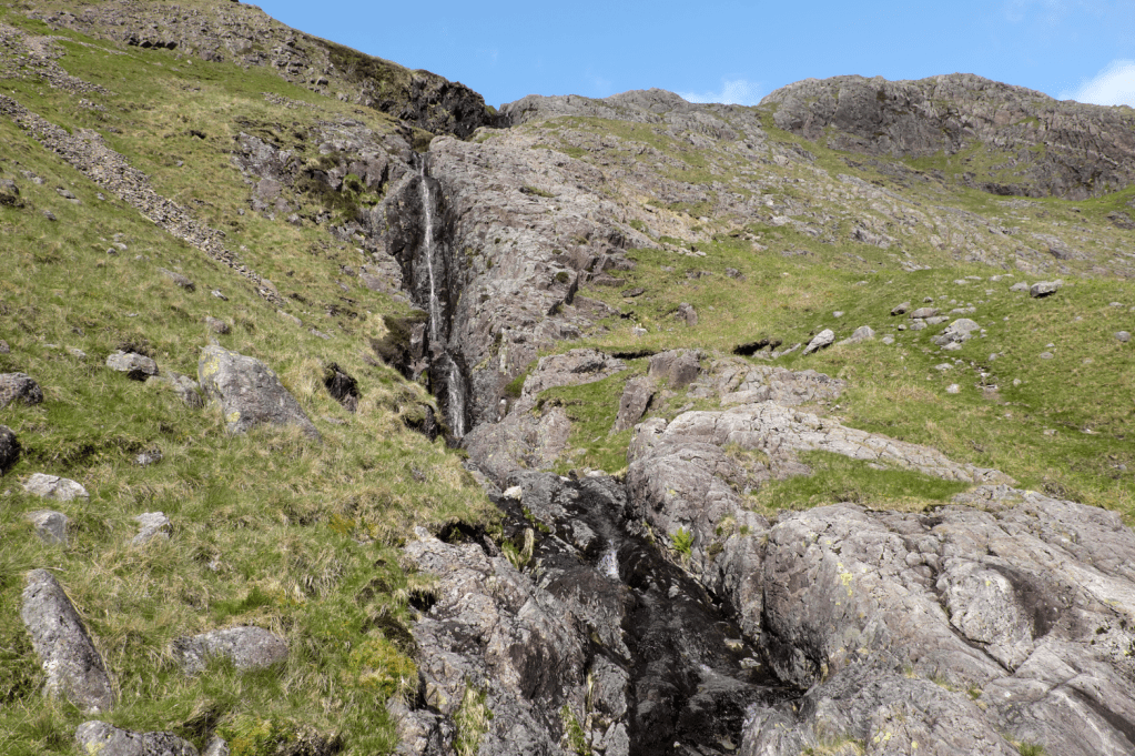 The route heads up the bare rock to the north of Cam Spout. Credit: Vivienne Crow