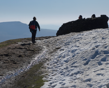 Walker nearing Whernside's summit, with Ingleborough in the distance_VCROW