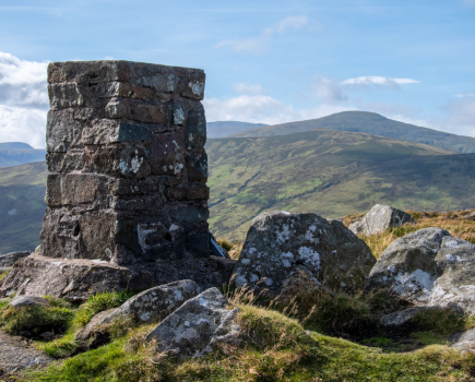 Summit of Tal-y-Fan with Carneddau Mountains in the distance