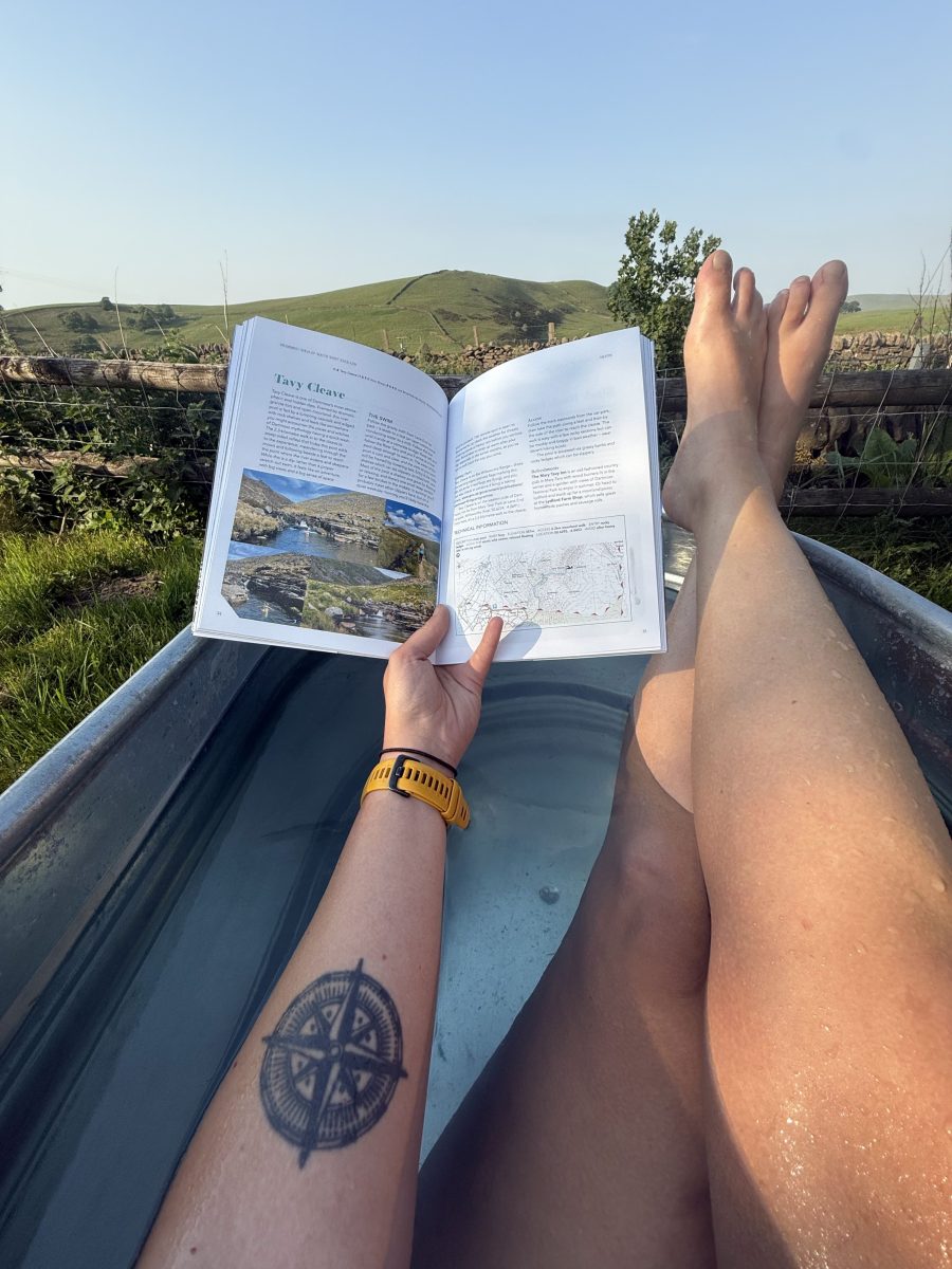 The reviewer dipping into the guidebook at home in the Peak District. Credit: Francesca Donovan