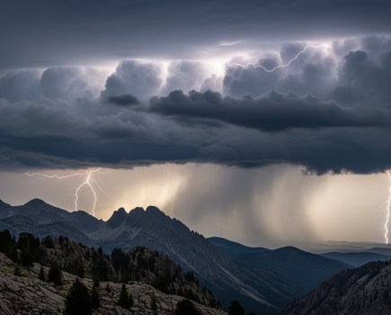 Lightning strikes through the clouds over the Rocky Mountains. Credit: Manazir Khan / Shutterstock