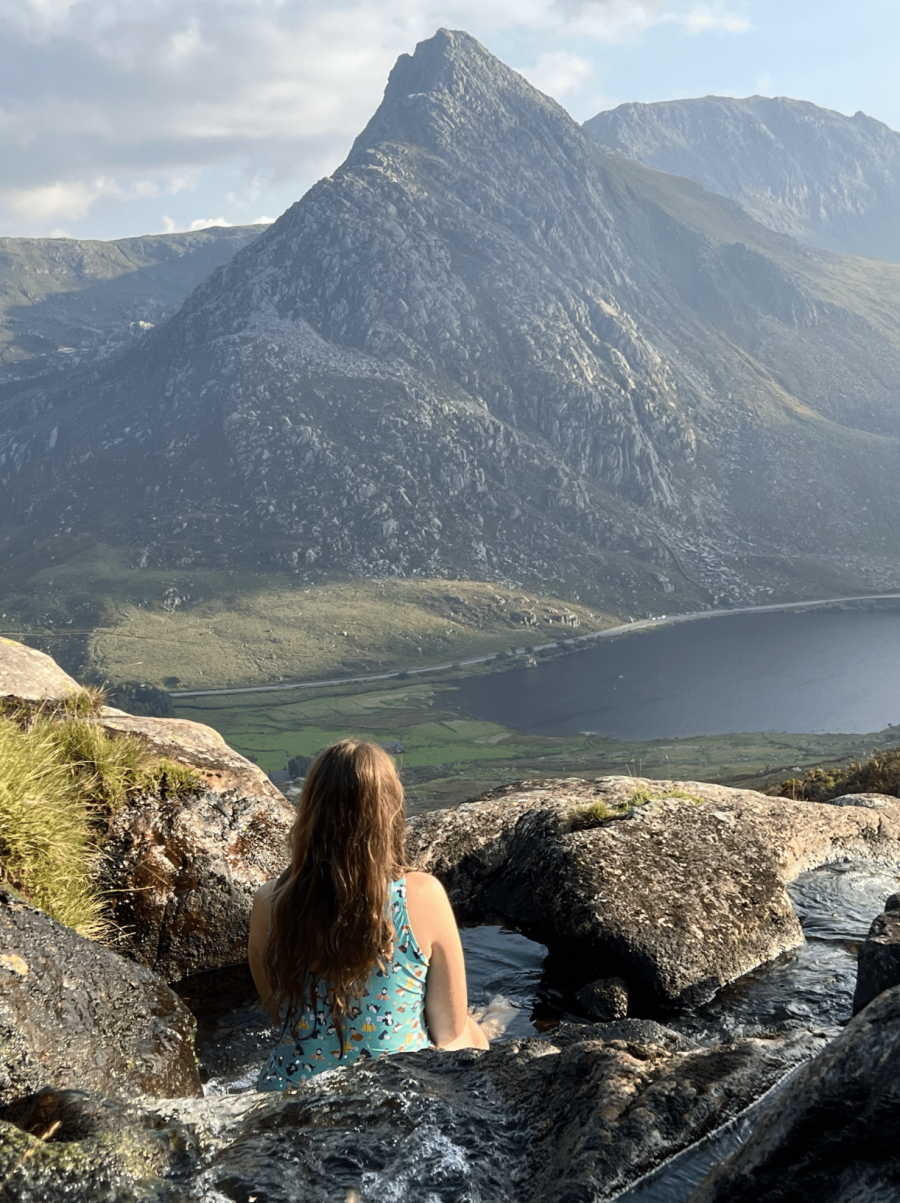 Cooling off in Afon Loer, Tryfan towering beyond. Credit: Francesca Donovan