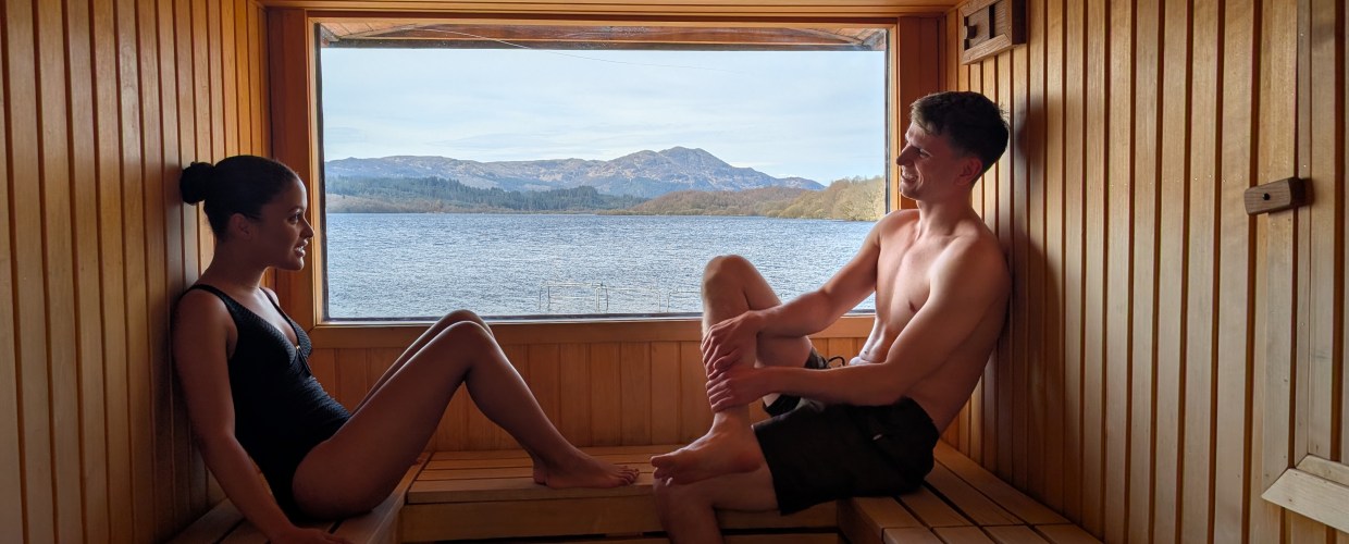DPS_A man and a woman in Venachar Lochside Sauna with a view of Loch Venachar and Ben Venue. Credit: Turnbulldouglas