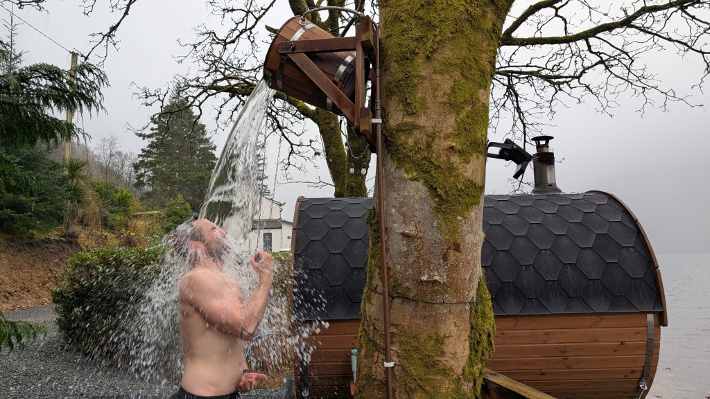 Jack using the plunge bucket outside Eir Sauna