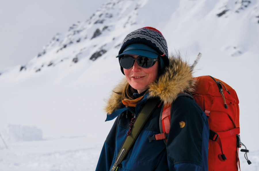 16.Jen with her gun. Though encounters are rare, the possibility of meeting a polar bear is always present