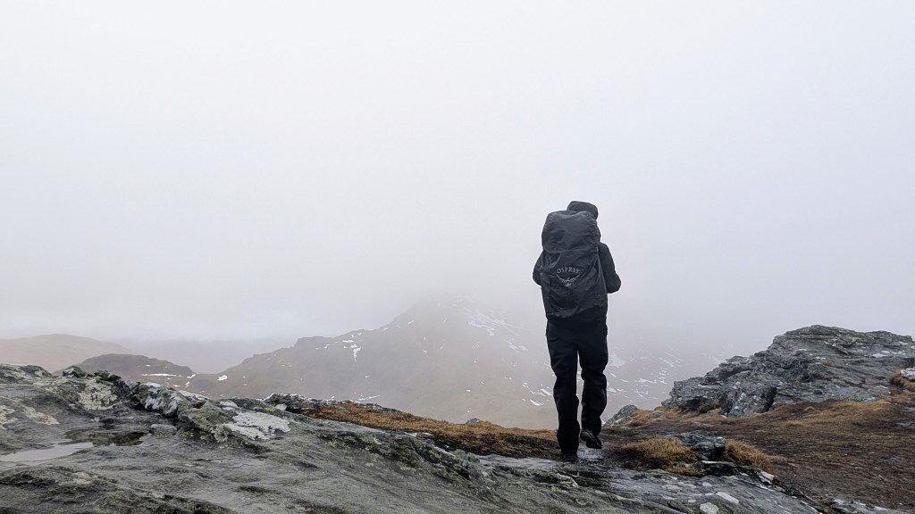 Walking to the summit of Beinn Tulaichean with a cloudy Cruach Àrdrain in the distance