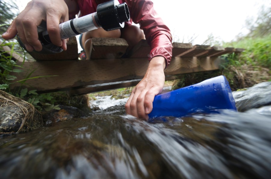 hiking health - Filter water for protection against stomach issues. Credit: Connect Images / Shutterstock 