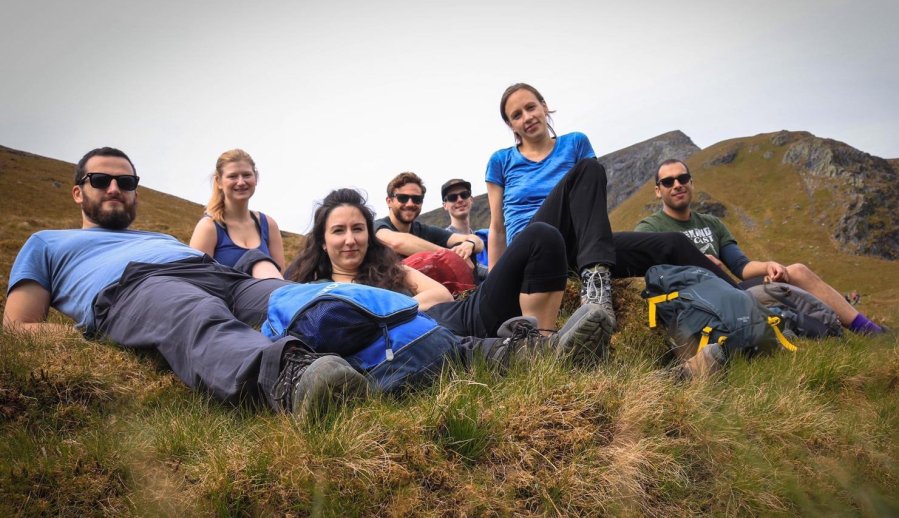 Group of walkers lying on a grassy incline