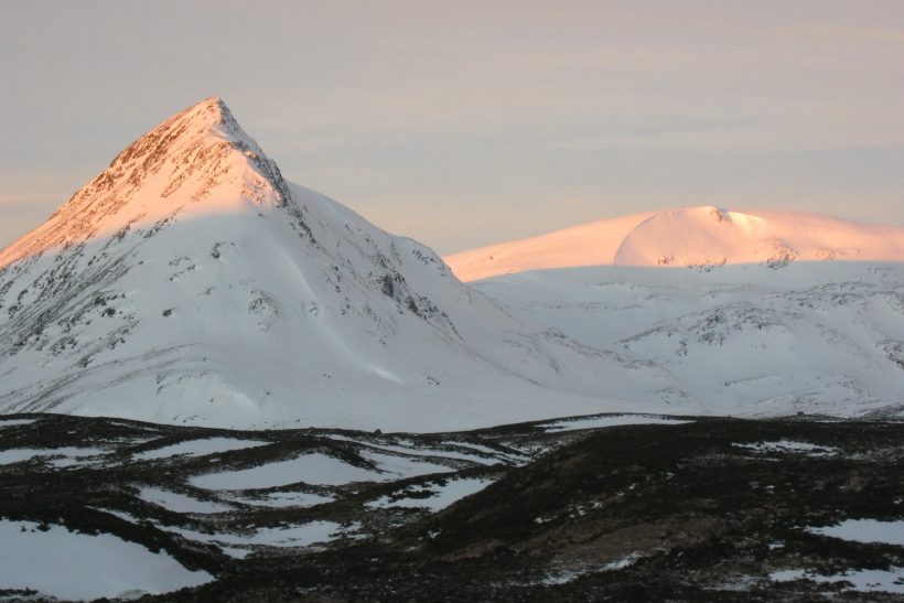 The shady approach to Geal-Charn mountain covered in snow