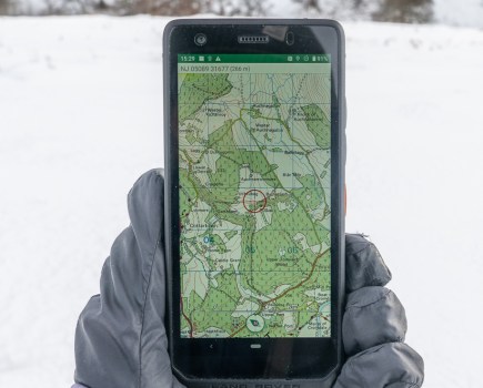 Land Rover Explore R Outdoor phone, displaying map, held by black glove