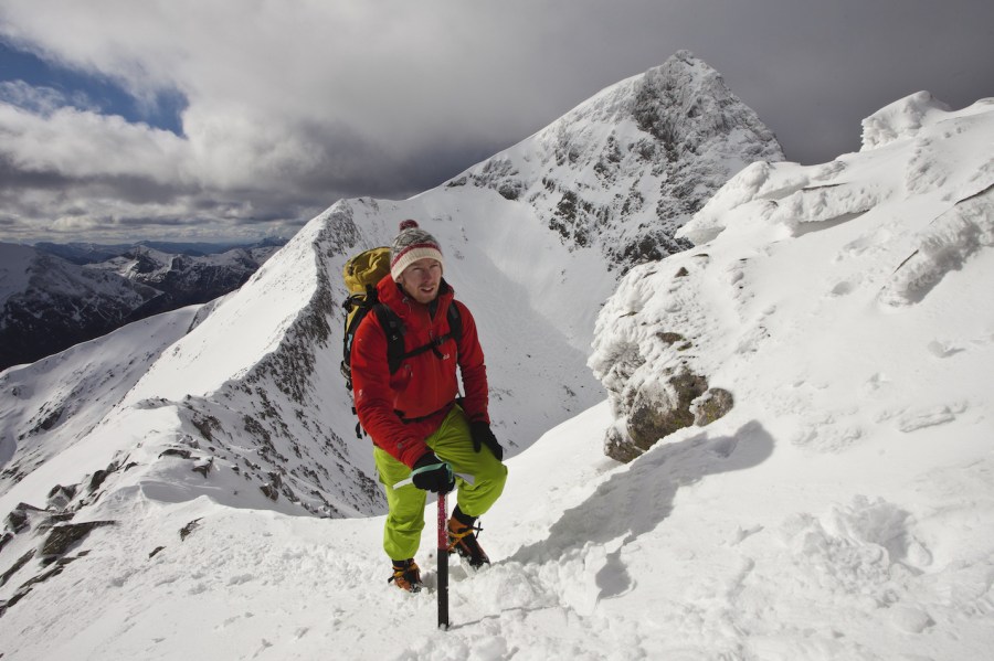 Climbing snowy mountain in winter mountaineering boots